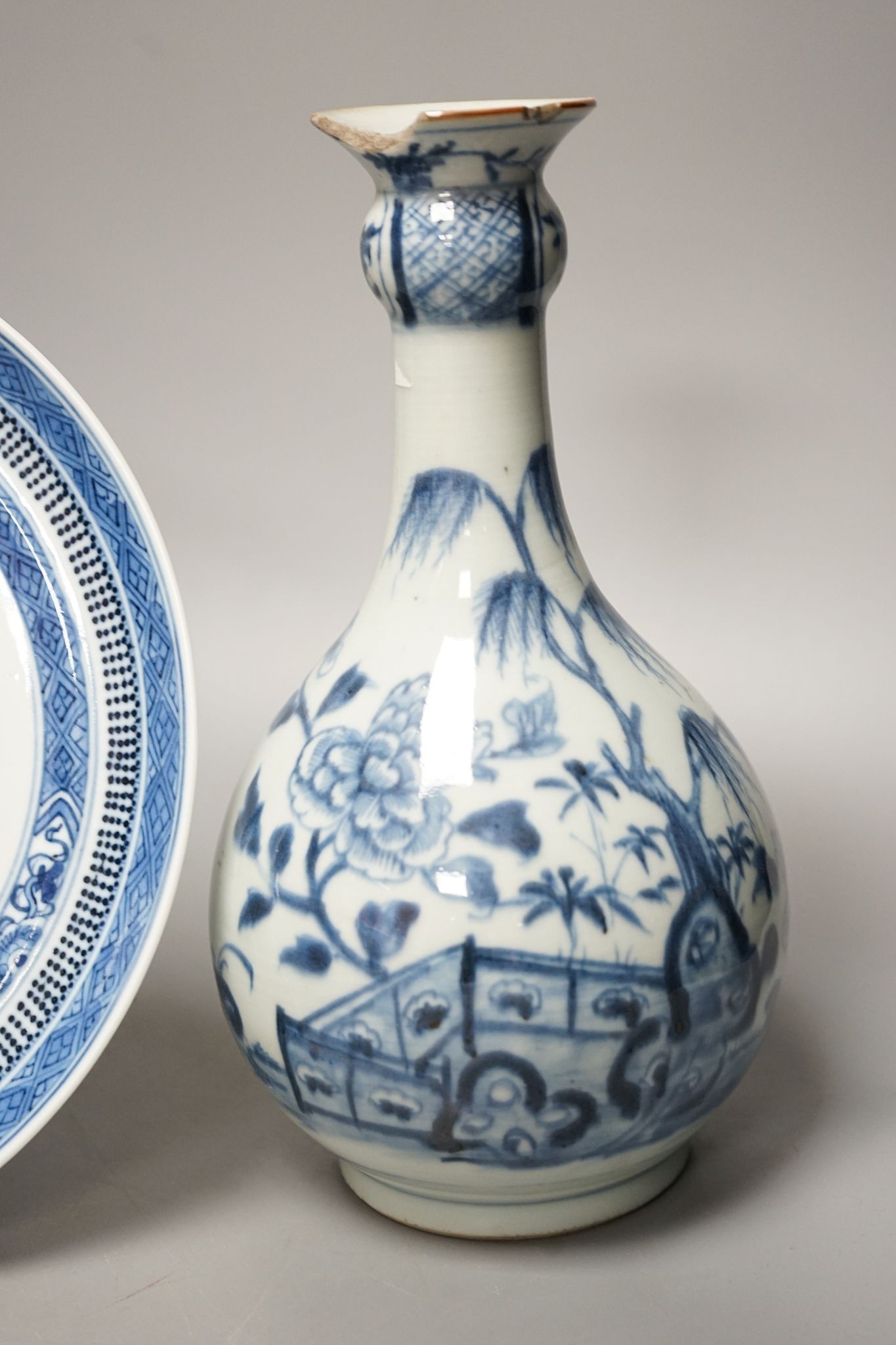 An 18th century Chinese blue and white bottle vase and two 19th century blue and white plates, diameter of largest plate - 25cm